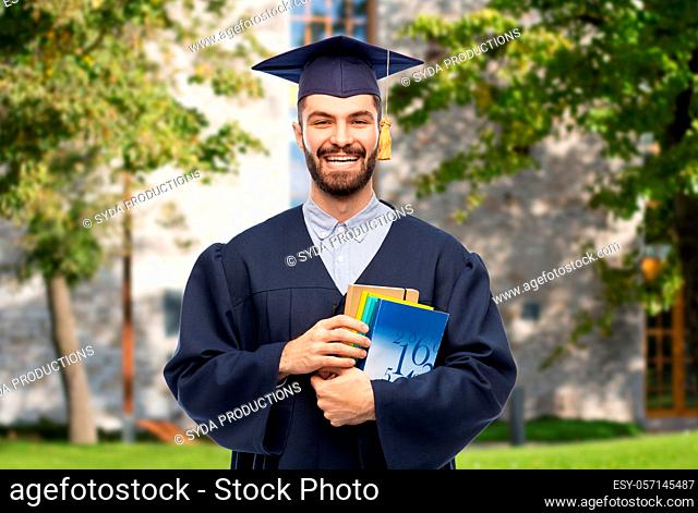 happy graduate student or bachelor with books