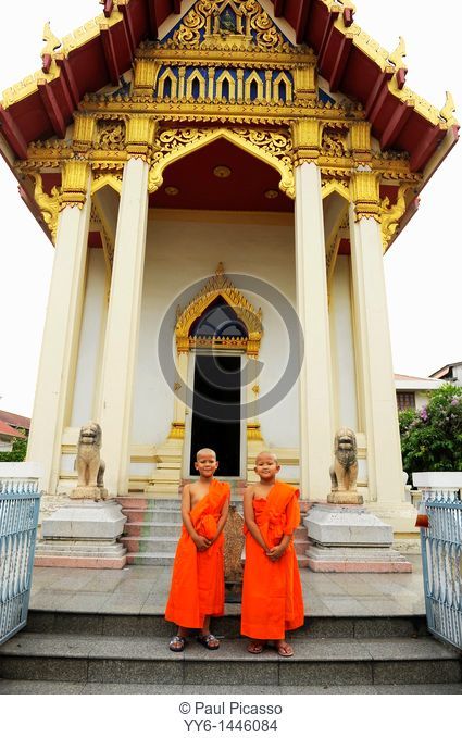 novices standing in front of Wat Santithammaram, temple famous for ordinations, thonburi, Bangkok, Thailand