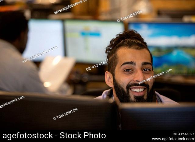 Portrait smiling young businessman working in office
