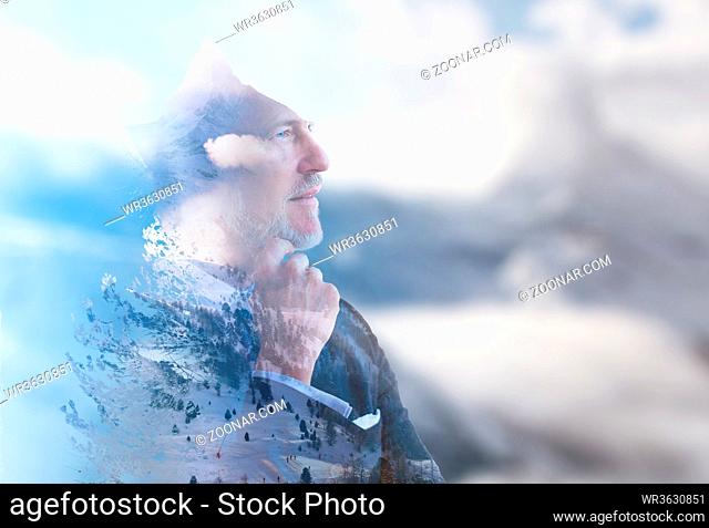 Double exposure of senior businessman in front of the big mountain