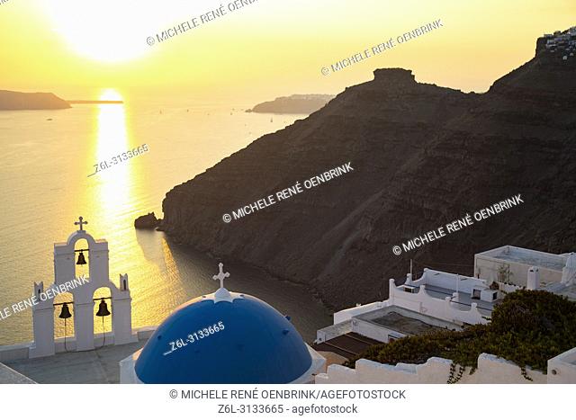 Blue Dome church and famous three bells with cross and steeple in Fira, Thira, Santorini Greece