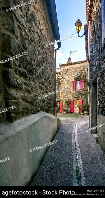 Village street in Aigne. The old village center of Aigne has the shape of a snail shell and was built in the 11th century