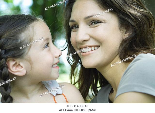 Girl smiling at mother, close-up