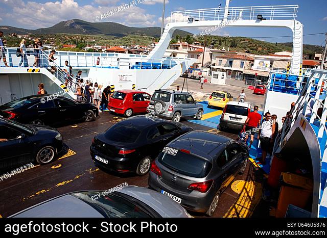 Glyfa village, Greece - August 15, 2023: Vehicles and people travelling from Evia island exiting ferryboat at the harbour of Glyfa in Greece