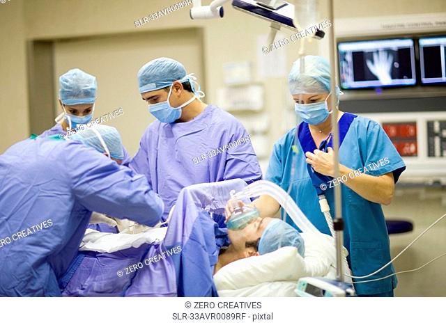 Doctor and nurses performing operation