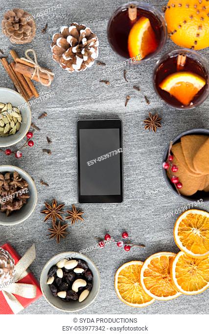 smartphone, hot mulled wine and christmas spices