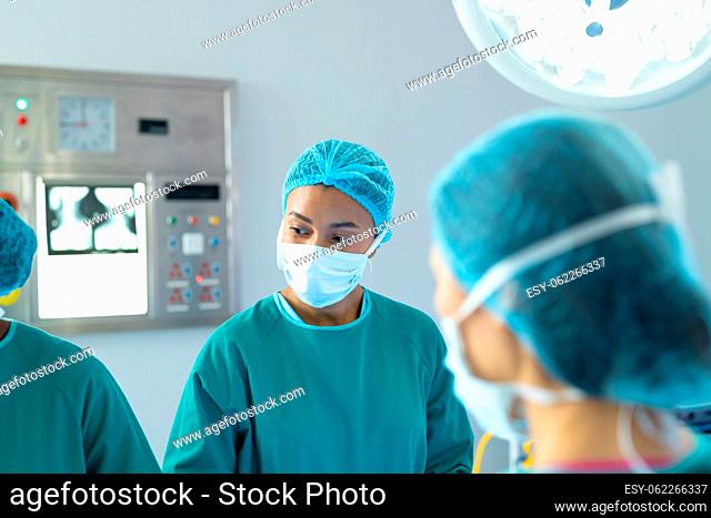Biracial female surgeon and female colleagues in theatre during operation