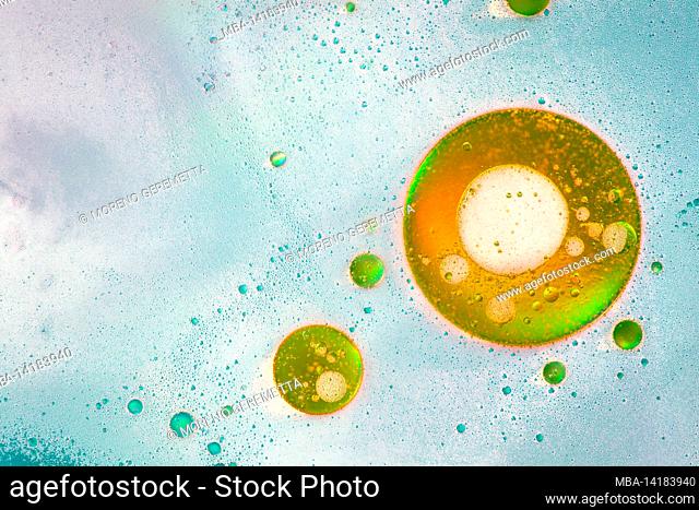 Oil bubbles on water surface, multicolored background, abstract image