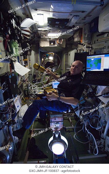 European Space Agency astronaut Andre Kuipers, Expedition 30 flight engineer, sets up the Environmental Health System Tissue Equivalent Proportional Counter...