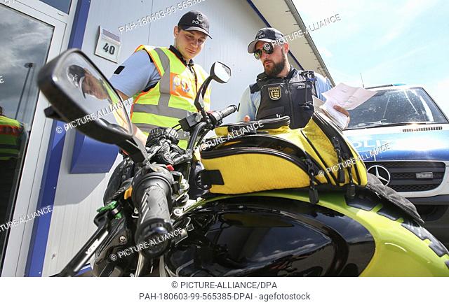 03 June 2018, Germany, Zwiefalten-Gauingen: Police officers check a motorbike during a control. Photo: Thomas Warnack/dpa