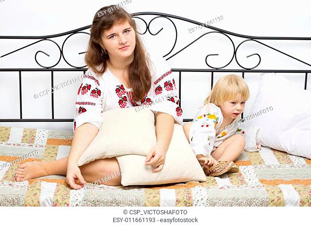 Two girls dressed in Ukrainian on the bed