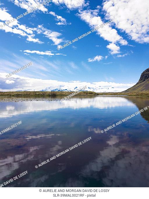 Clouds and mountains reflected in lake