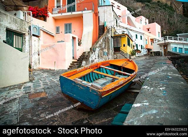 View of the Port of Corricella with lots of colorful houses on a sunny day in Procida Island, Italy
