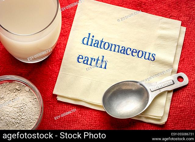 food grade diatomaceous earth supplement - powder and in a glass of water with a measuring spoon and a napkin with text