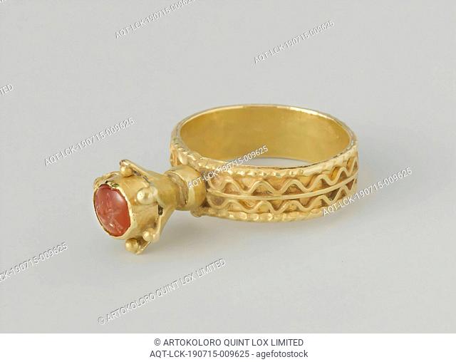 Ring with a carved carnelian ring, Gold ring. Consisting of a wide, flat band with soldered gold wire. In a tall cupboard in the shape of a flower calyx