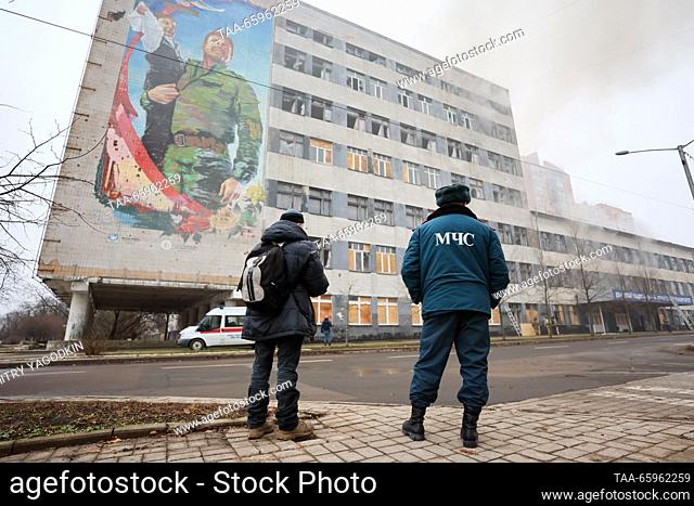 RUSSIA, DONETSK - DECEMBER 21, 2023: An employee of Russia's Emercom stands before the fire-hit Building 3 of the Donetsk National Technical University after a...