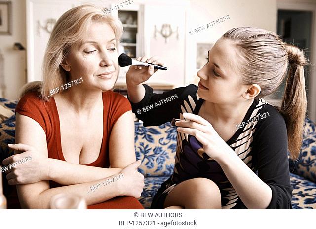 Mother and daughter doing make up