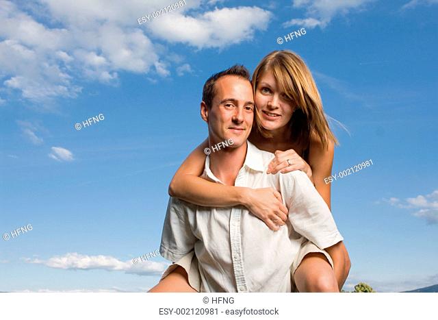 Young lovers piggy back