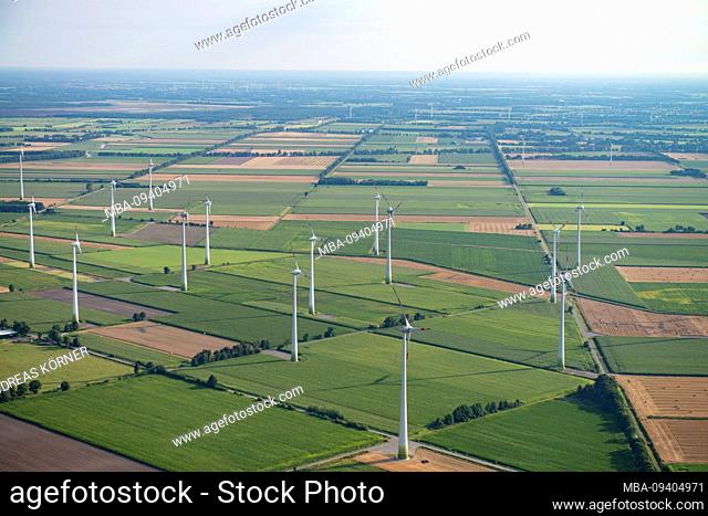 Aerial view of a landscape of agricultural fields and wind turbines