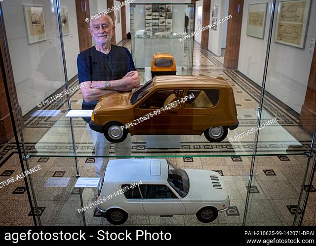 25 June 2021, Saxony, Chemnitz: In the Chemnitz Art Collections, the designer Karl Clauss Dietel stands behind a display case with models for the Trabant P601 N...