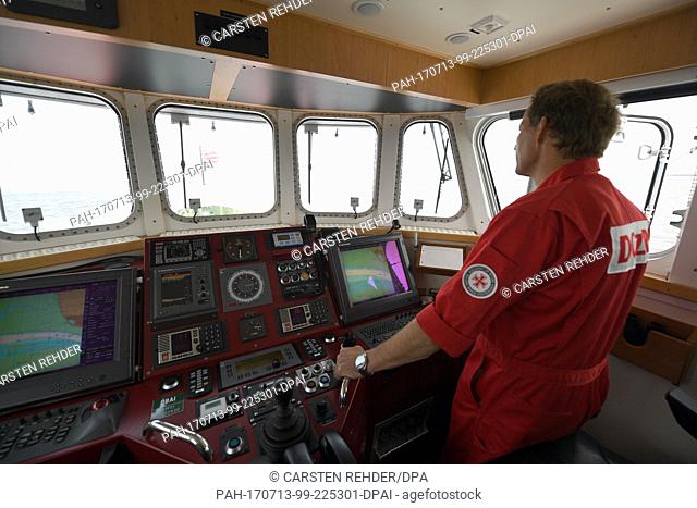 Foreman Joerg Luedtke steers the rescue cruiser 'Theodor Storm' on the North Sea off Buesum,  Germany, 11 July 2017. The German Maritime Search and Rescue...