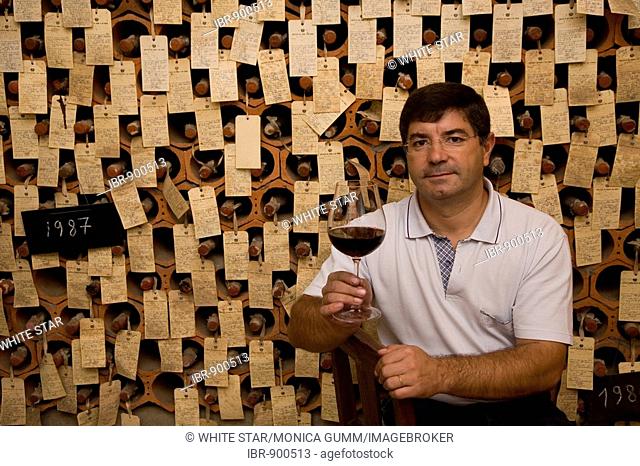 Oenologist, Oscar Gato, in the bodega, wine cellar, where all of the sample bottles of the exporter are stored, Adega Cooperativa de Borba, Alentejo Region