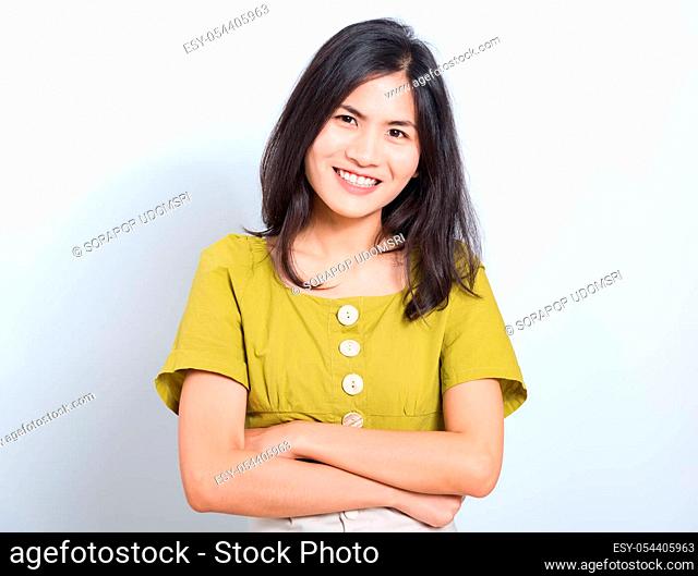 Portrait Asian beautiful young woman standing smile seeing white teeth, She crossed her arms and looking at camera, shoot photo in studio on white background