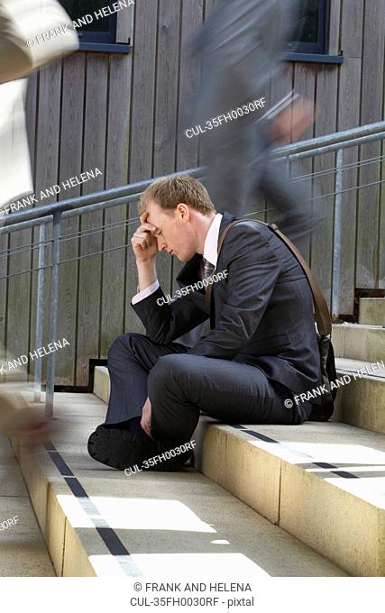 Time lapse view of depressed businessman