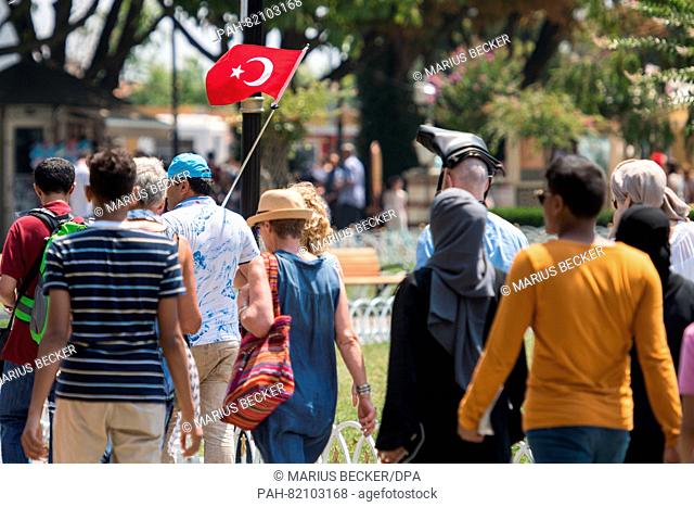 Tourist follow a guide with a turkish flag at the historic center in Istanbul, Turkey, 17 July 2016. Turkish authorities said they had regained control of the...