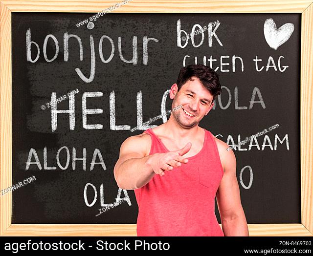 Woman near words hello in different languages on chalkboard