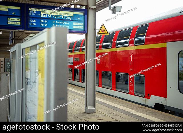 06 May 2021, Schleswig-Holstein, Husum: A DB Regio double-decker train heading for Sankt Peter-Ording stands on a track at Husum station as part of the...