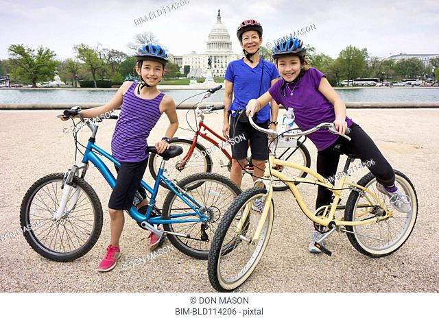 Mother and daughters riding bicycles by Capitol Building, District of Columbia, United States