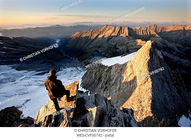 Austria, Tyrol, Zillertal Alps, View from Reichenspitze, climber at glaciated mountains at sunrise, Wildgerlostal, High Tauern National Park