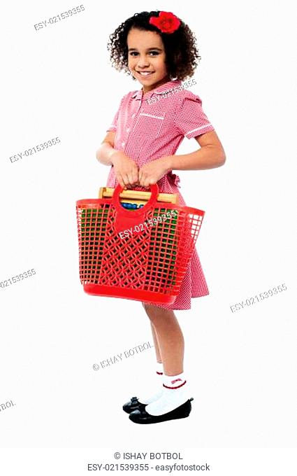 Charming kid carrying school stationery