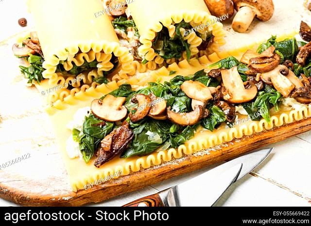 Lasagne with mushrooms, champignons, cheese and spinach. Traditional Italian food