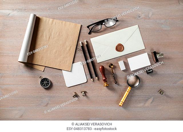 Blank envelope and vintage stationery on wood table background. Flat lay