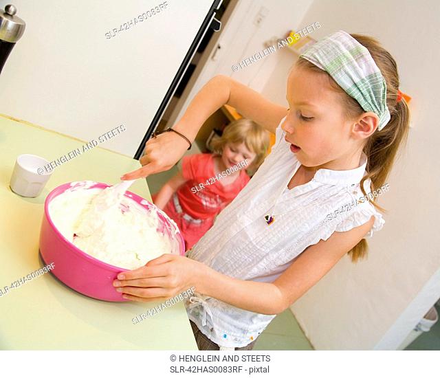 Girl mixing in bowl in kitchen
