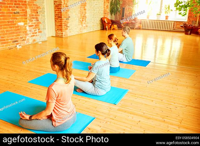 group of people making yoga exercises at studio