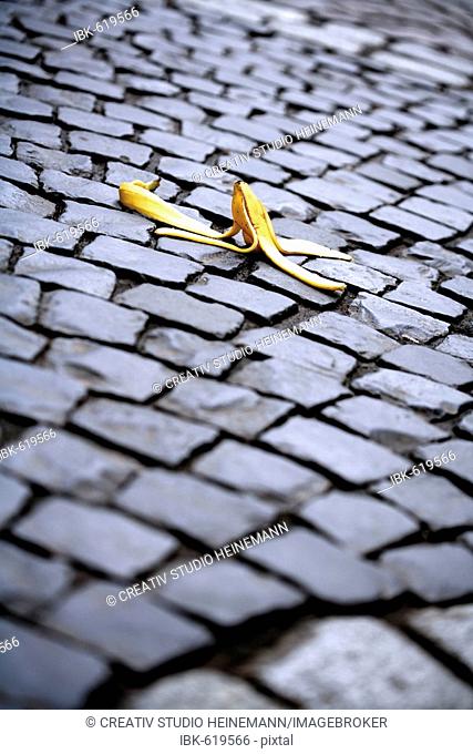 Banana peel on cobblestones, symbol for accident risk