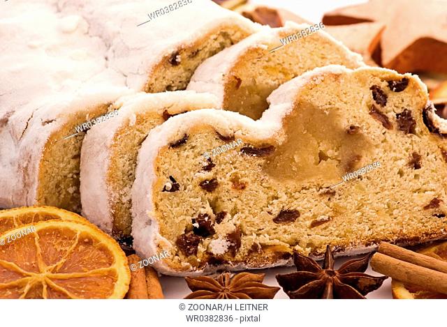 Marzipan stollen with Christmas decoration as closeup on white background