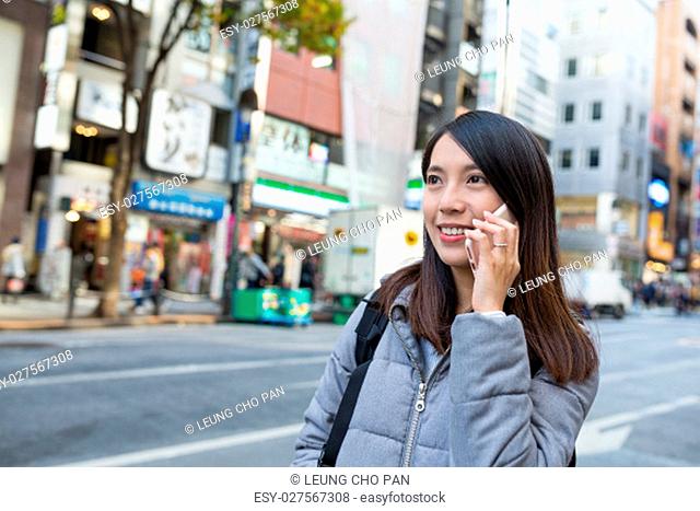 Woman talk to cellphone at tokyo city