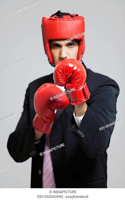 Businessman with boxing gloves in boxing stance