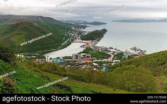 Summer cityscape of Kamchatka Peninsula: scenery top view of seaport, center of Petropavlovsk-Kamchatsky City, mountains along shores of Avacha Bay...