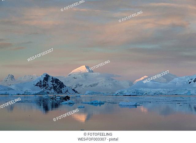 South Atlantic Ocean, Antarctica, Antarctic Peninsula, Lemaire Channel, View of snow coverd mountain range at dawn