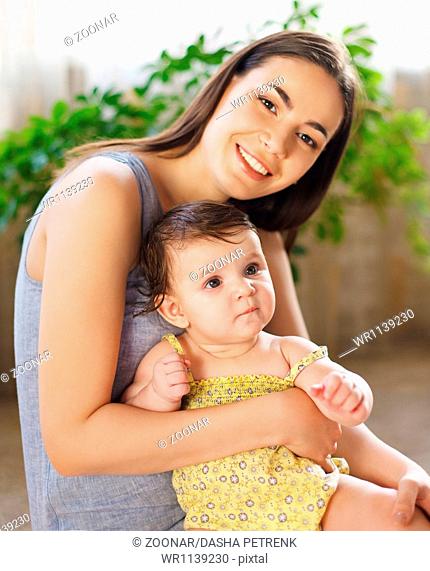 Happy smiling mother with eight month old baby