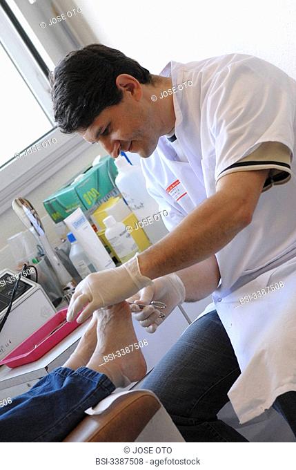 Photo essay from the University Hospital of Bordeaux. Cardiologic hospital of Haut-Leveque. Department of diabetology. A chiropodist curing the feet of a...
