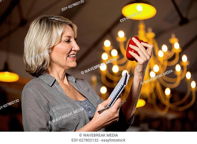 Female costumer checking bell pepper