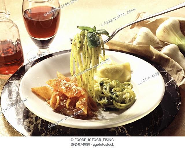 Assorted pastas on a dish with wine and garlic