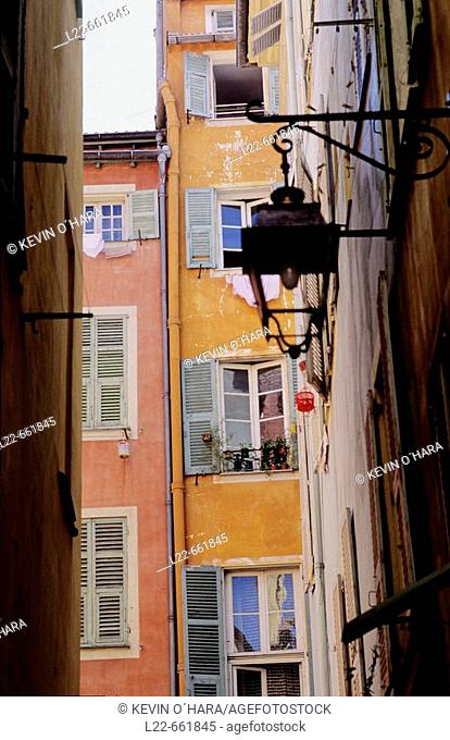 The 'vieille ville' with narrow streets curving in irregular fashion between old buildings with red-tile roofs. City of Nice. Alpes-Maritimes