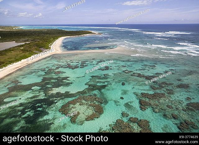 Aerial view of a deserted beach, coral formations and turquoise waters along the coastline on the Atlantic Ocean side of Cat Island, Bahamas